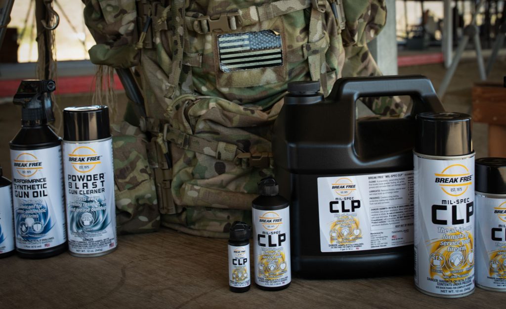 Break Free gun cleaning products arranged on a table with a camouflage pack.