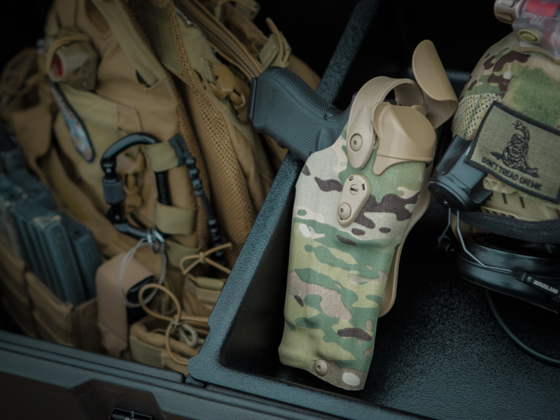 Safariland cordura wrapped RDS holster in a box with tactical gear.