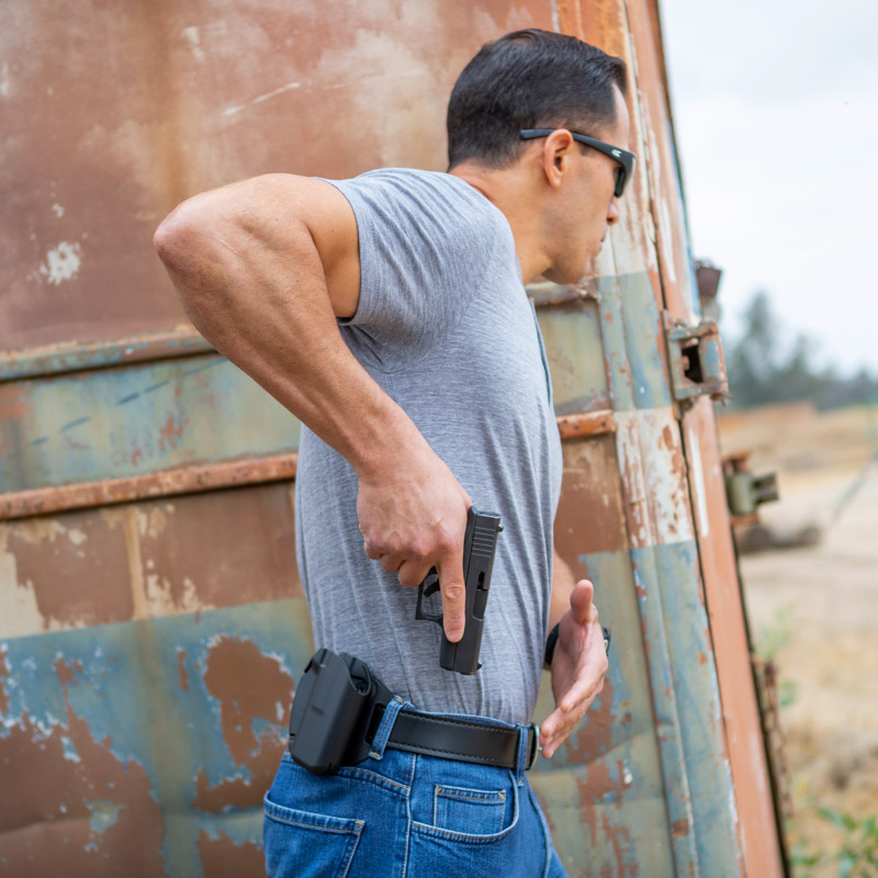 man drawing pistol from Safariland OWB Holster