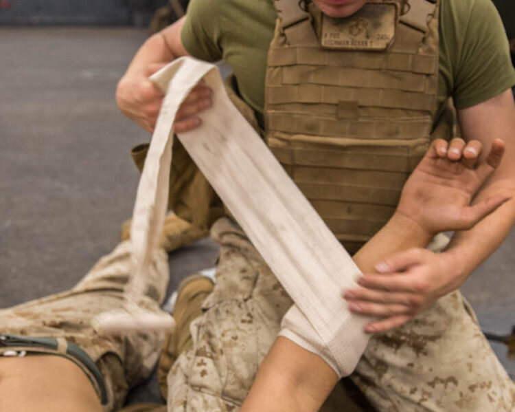 Marine working with a bandage