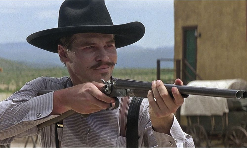 Val Kilmer as Doc Holiday in Tombstone, with a coach gun.