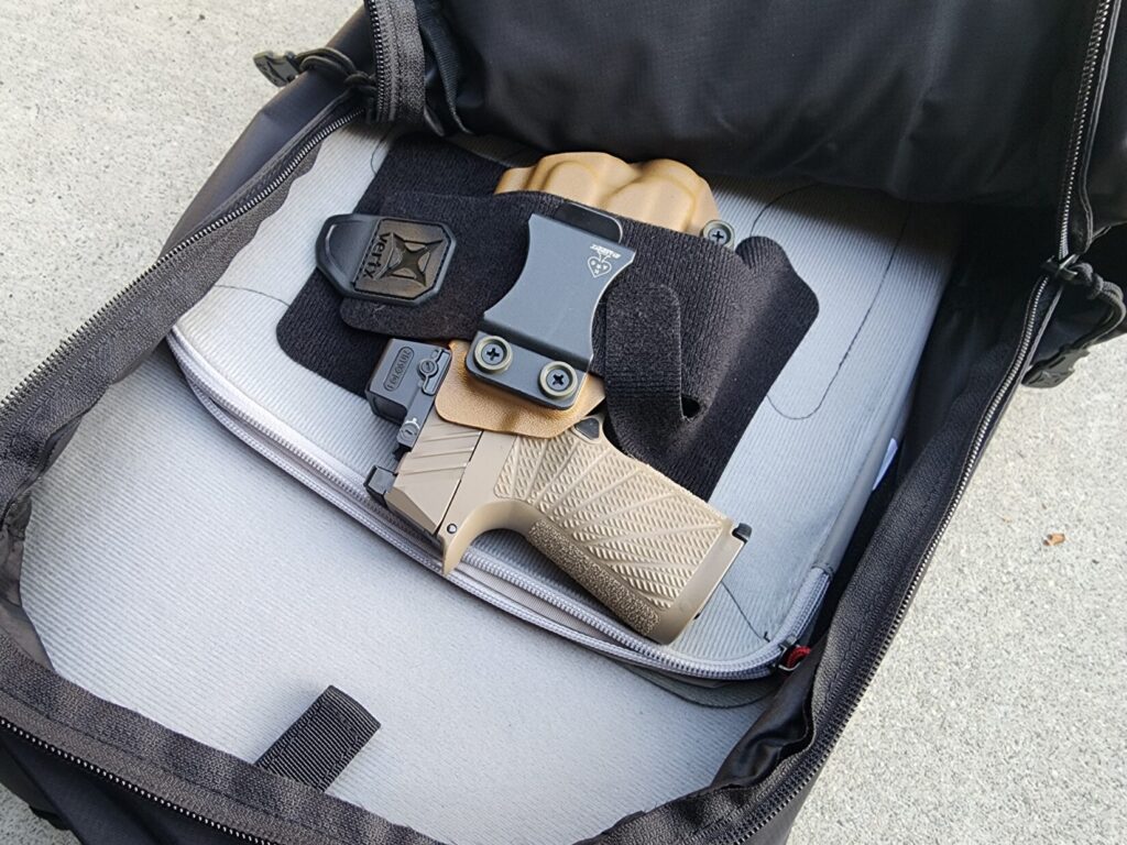 Close up of a pistol in an off body carry bag.