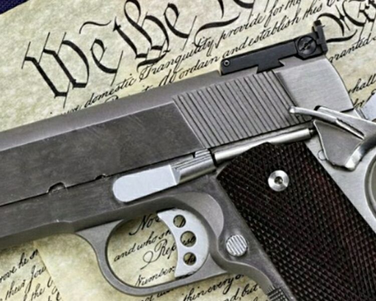 1911 pistol with the Constitution and American flag