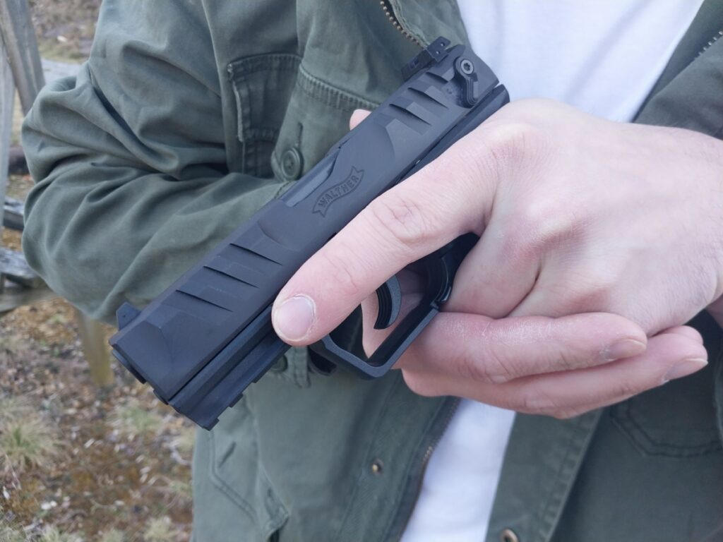 Man's hands holding semi-automatic pistol