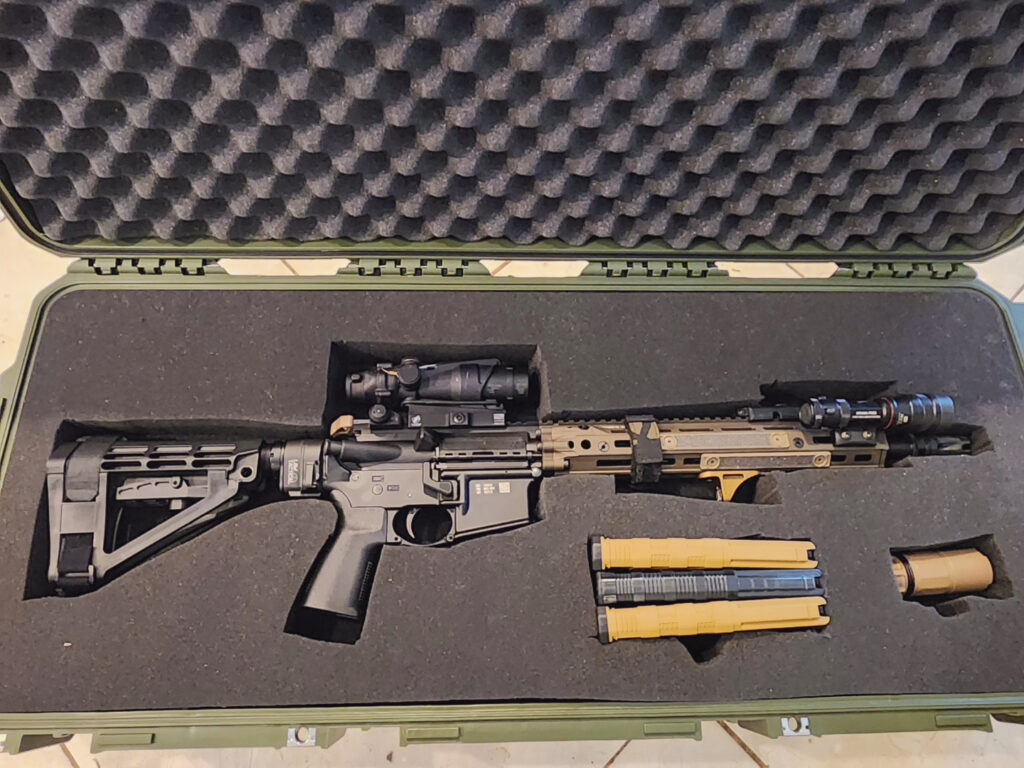 AR-15, magazines, and muzzle blast shield in foam cutaways in hard rifle case