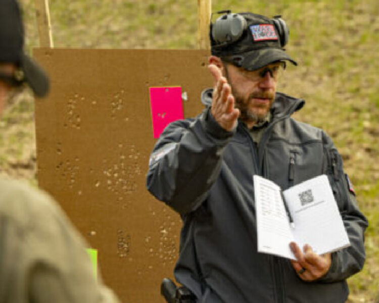 Rick Hogg with Firearms Training Notebook at shooting range