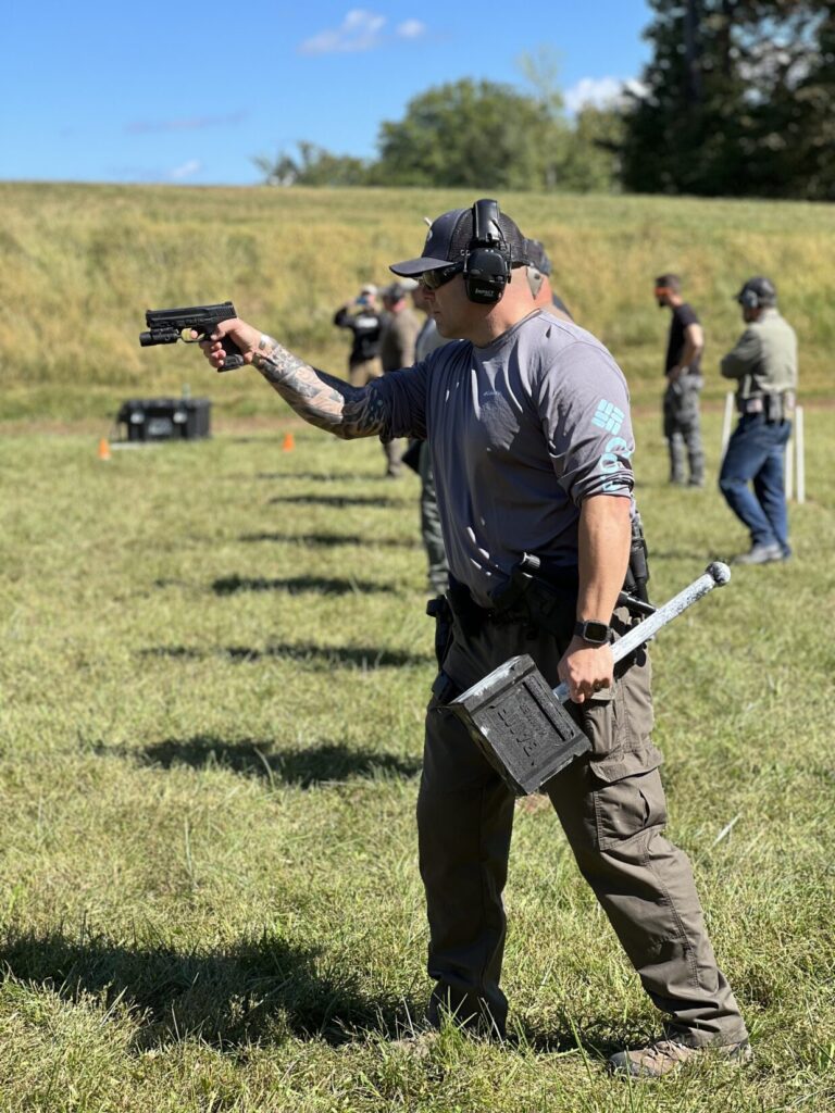 K9 officer shooting one handed holding a BAMF hammer 