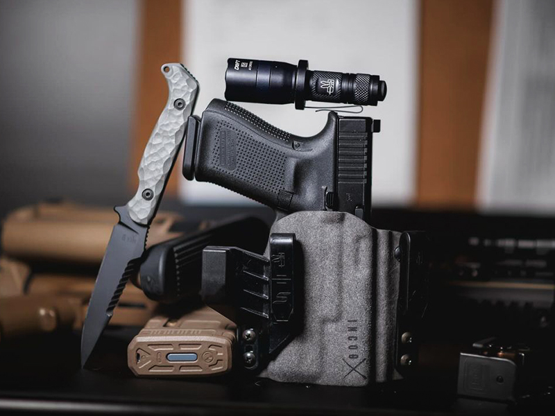 Safariland IncogX holster with a Glock, handheld flashlight, knife, and spare magazines