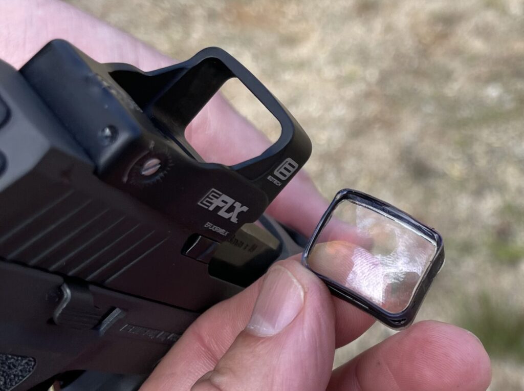 pictured is an open emitter red dot sight with a lens popped out 