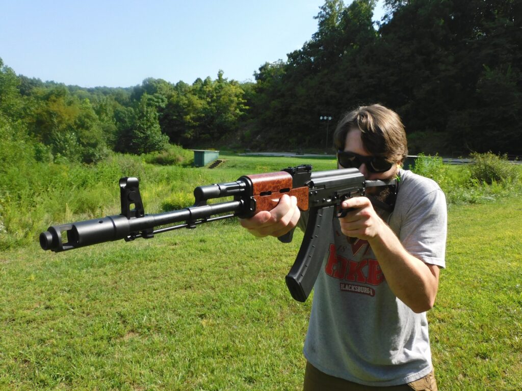 Man firing an AK rifle