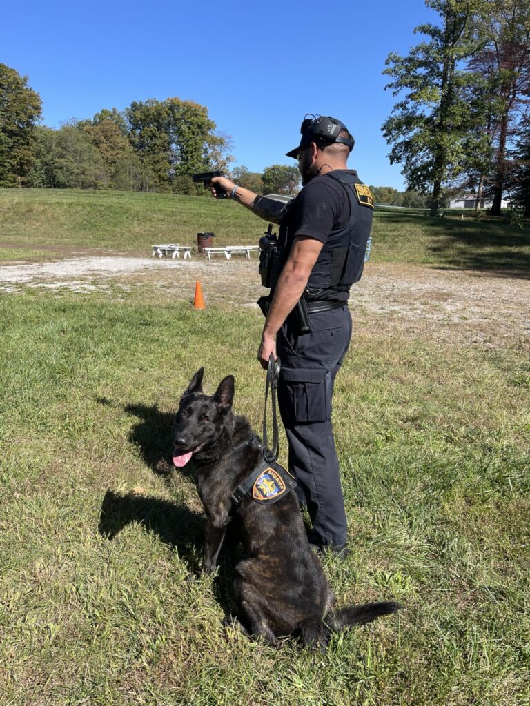 A law enforcement K9 officer with his canine conducting dry fire training with War HOGG Tactical