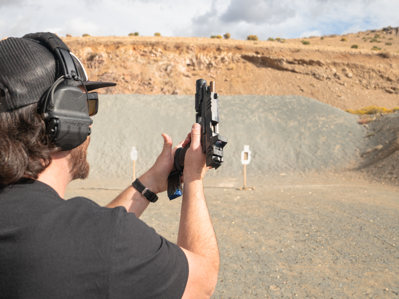 reloading handgun at outdoor range - wearing liberator hearing protection