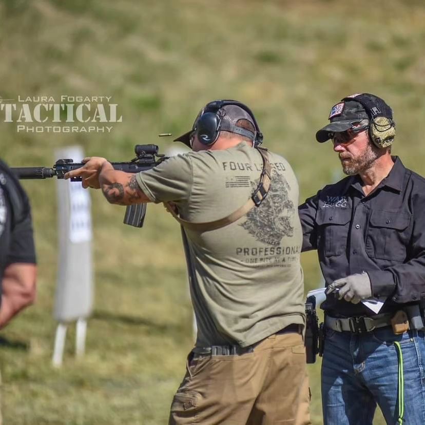 A Law Enforcement Officer is firing a shot with his carbine