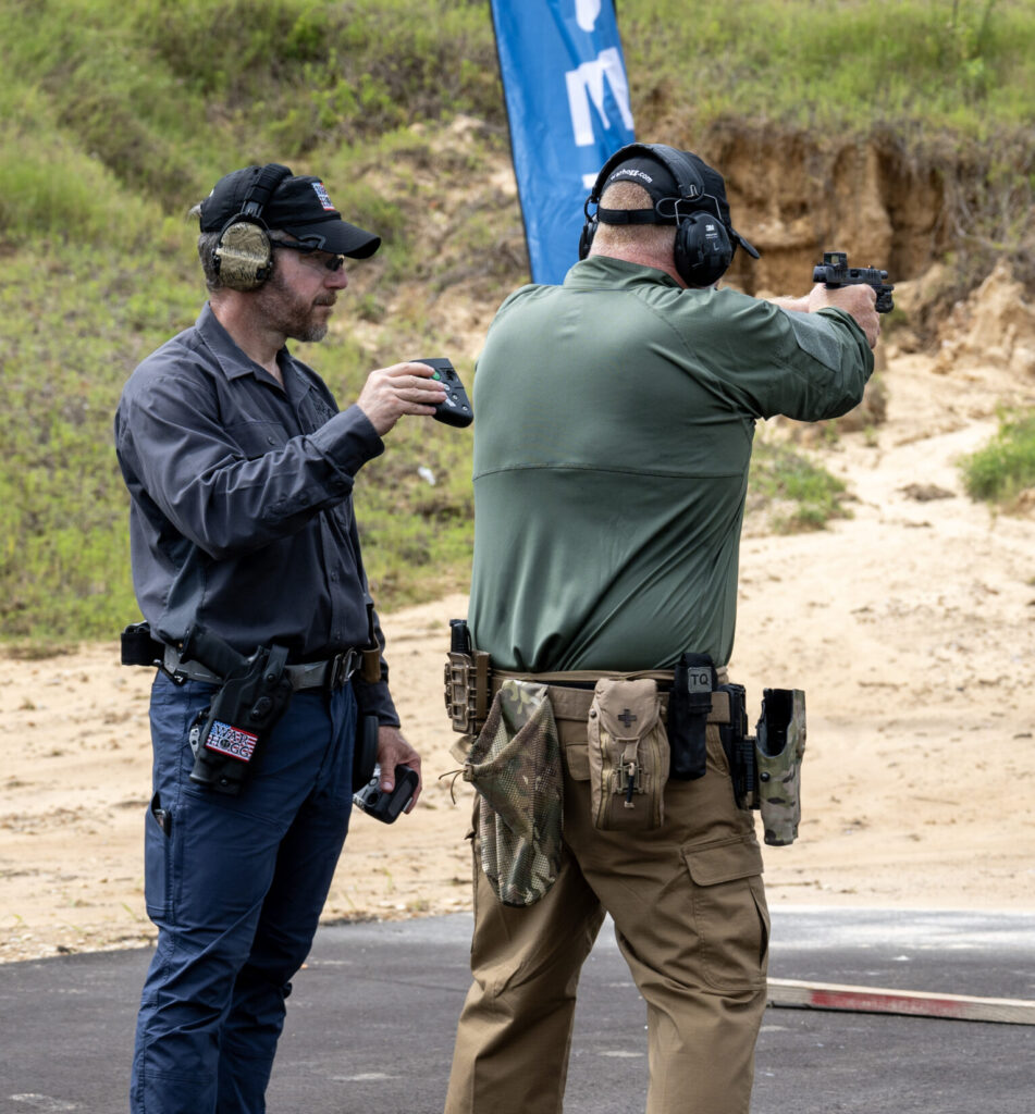 Rick Hogg collecting shooting data from a student during a law enforcement red dot pistol course