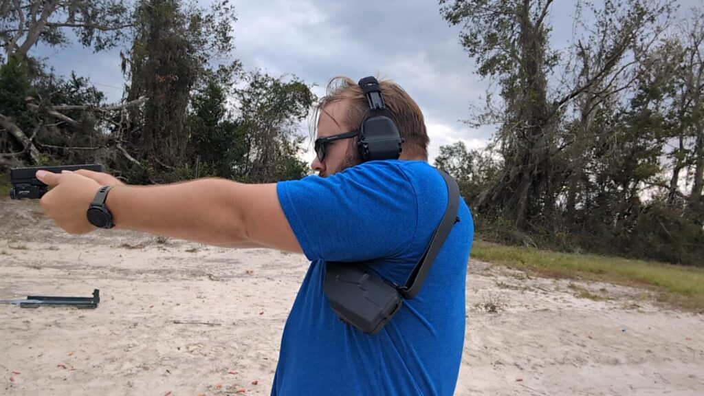 man shooting with shoulder holster