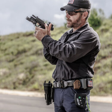 Rick Hogg of War HOGG Tactical demonstrating using the support thumb to release the slide catch during a speed magazine change during a "Project Officer Survival" FREE law enforcement firearms training course supported by Walther, Aimpoint, Safariland and Propper