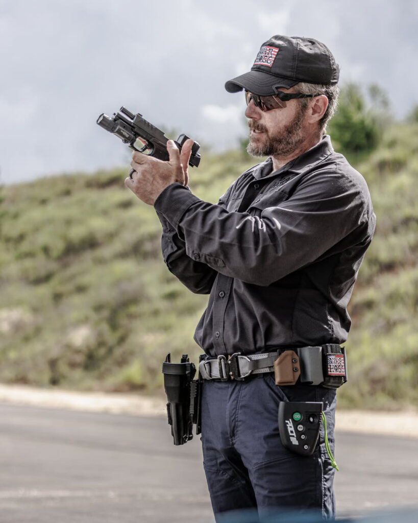 Rick Hogg of War HOGG Tactical demonstrating using the support thumb to release the slide catch during a speed magazine change during a "Project Officer Survival" FREE law enforcement firearms training course supported by Walther, Aimpoint, Safariland and Propper