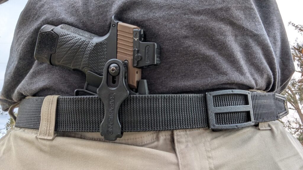 holosun red dot on handgun, holstered in Safariland IWB holster worn appendix position