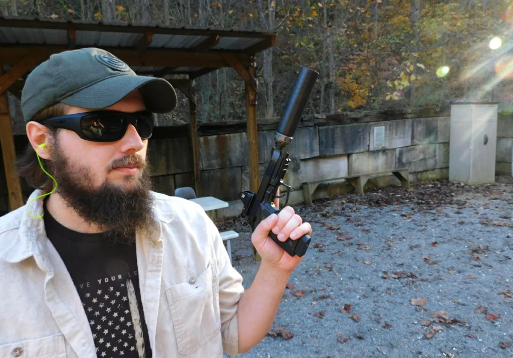 man holding a Beretta pistol