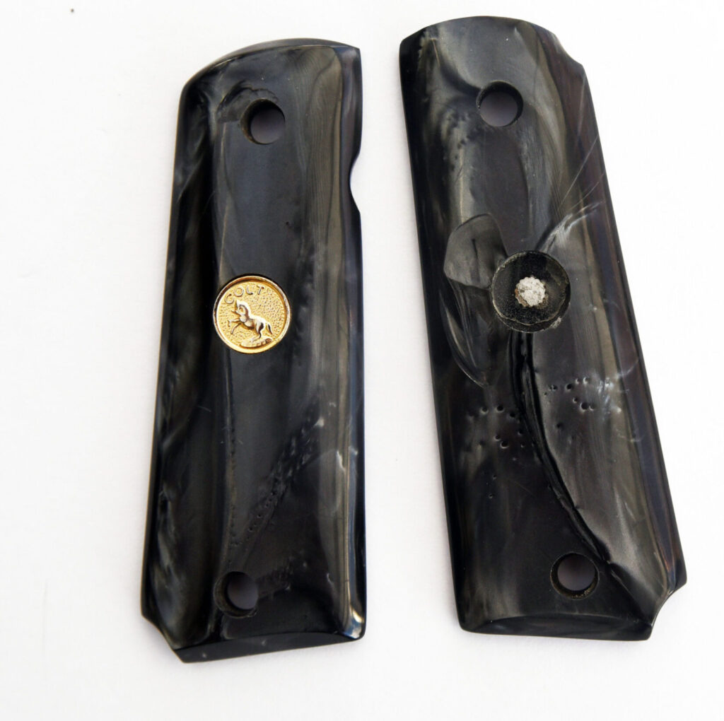 damaged Ajax Black Pearlite grips from Colt 1991 Combat Commander