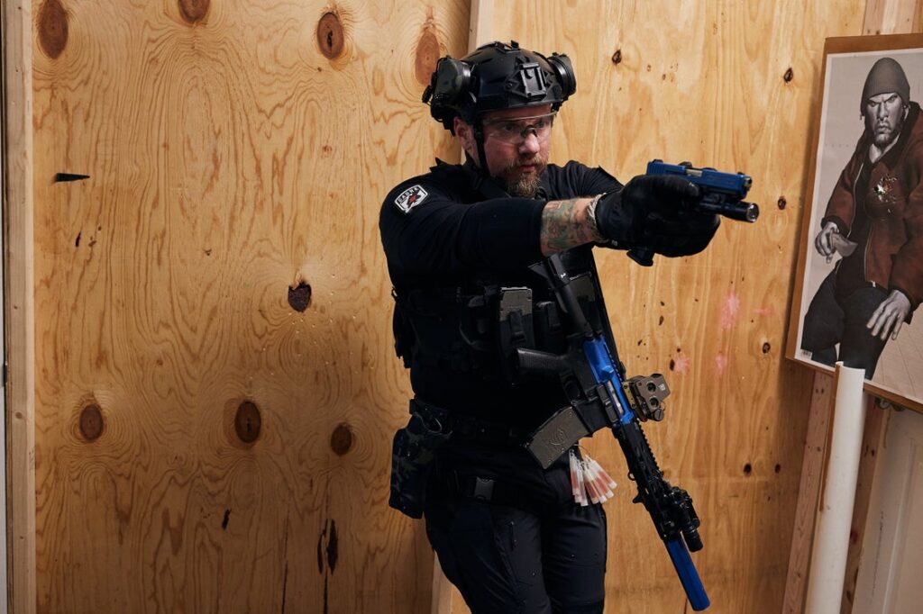 Kyle Morgan in shoot house with training firearms