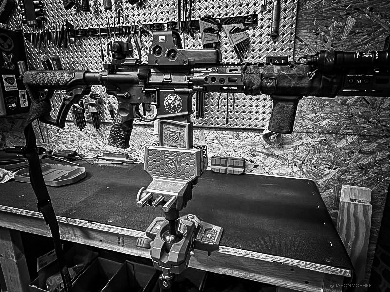 black and white photo of a rifle in a gun vise