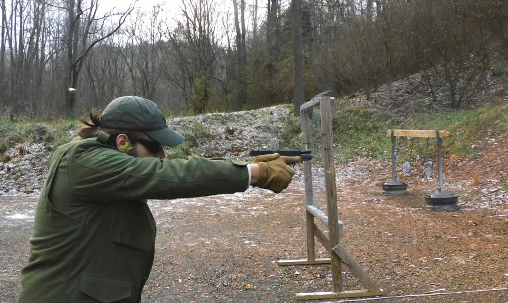 man shooting a semi-automatic pistol