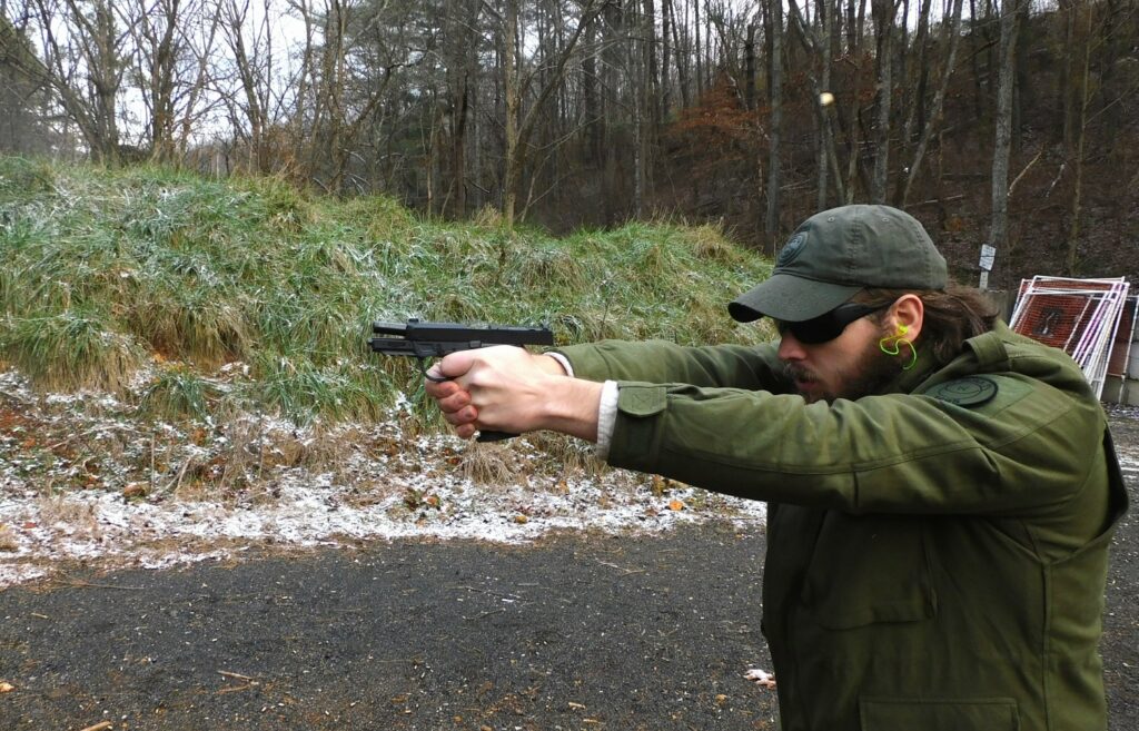 man firing a semi-automatic pistol