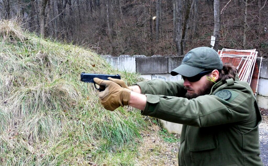 man firing a semi-automatic pistol