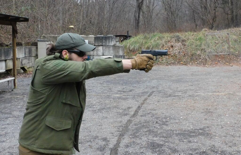 man shooting a semi-automatic pistol