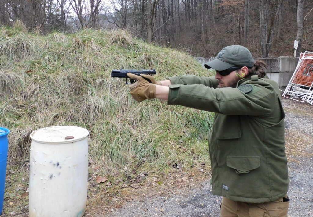 man shooting a semi-automatic pistol