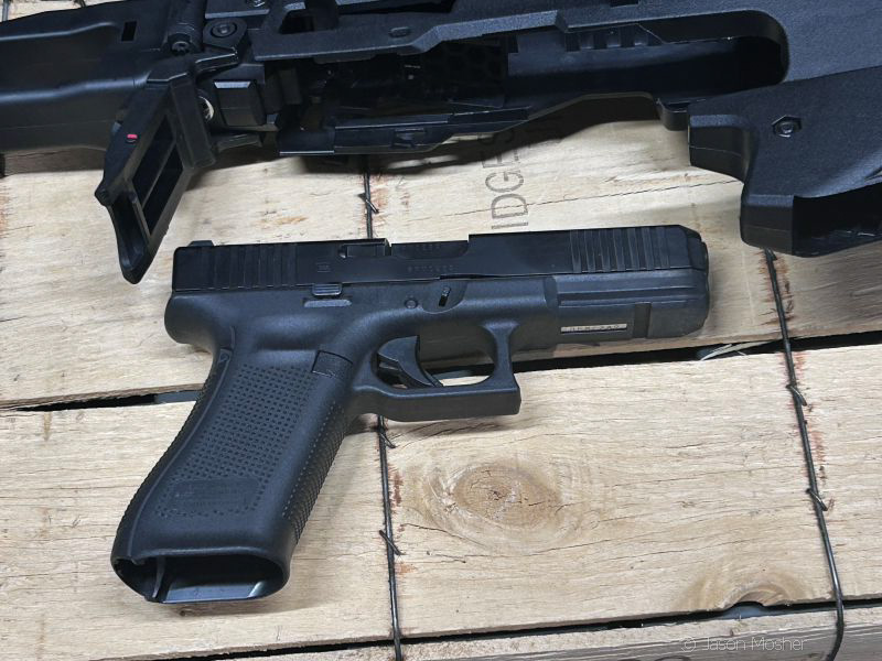 Glock handgun positioned under the MCK Conversion Kit to show how it inserts