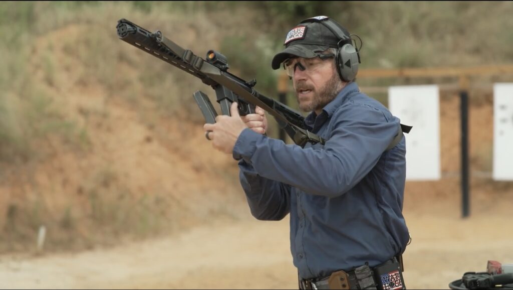 The picture is a link to watch Rick Hogg of War HOGG Tactical conduct a tactical magazine change with a carbine