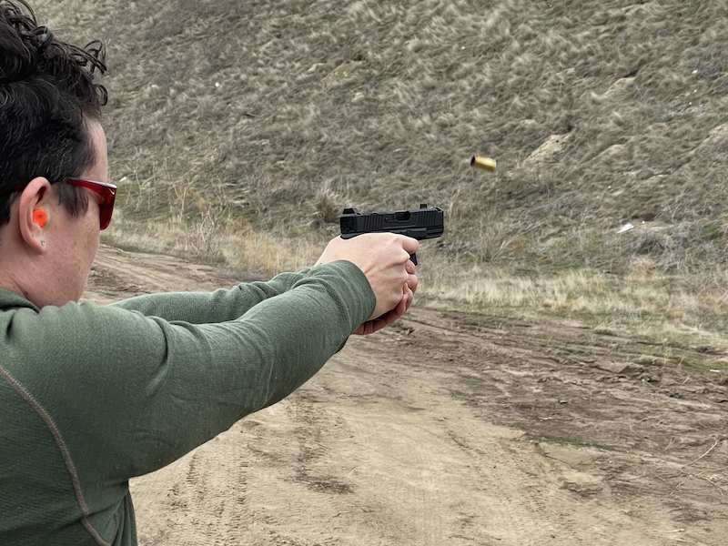 Woman shooting Angled Spade Imperium 9C on range