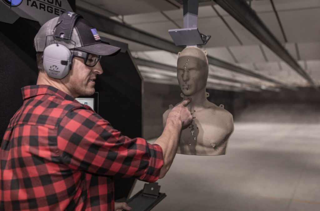 Man examining shots in 3D target