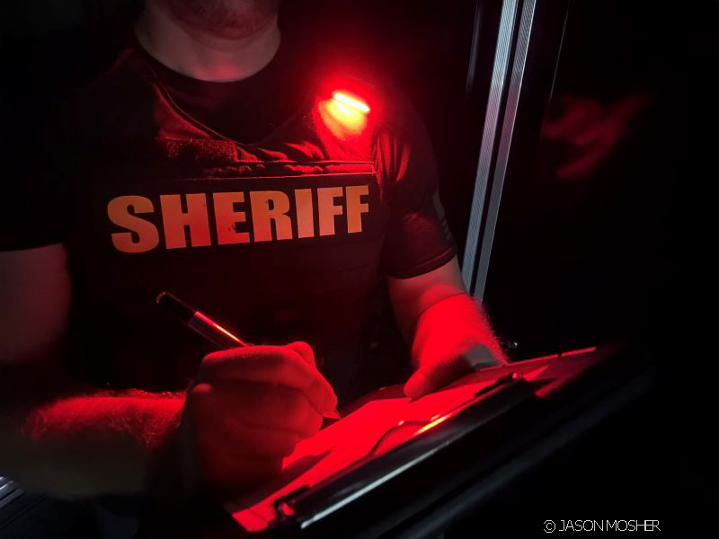 red Gear Light on Sheriff's vest at night