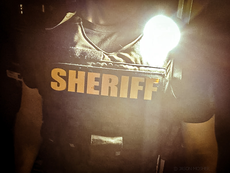Gear Light attached to sheriff's vest, turned on