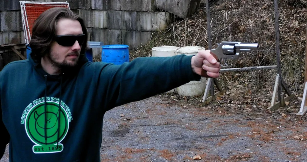 man firing revolver