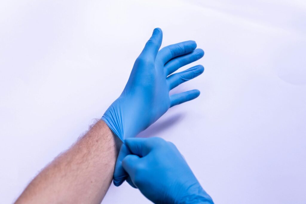 donning nitrile gloves