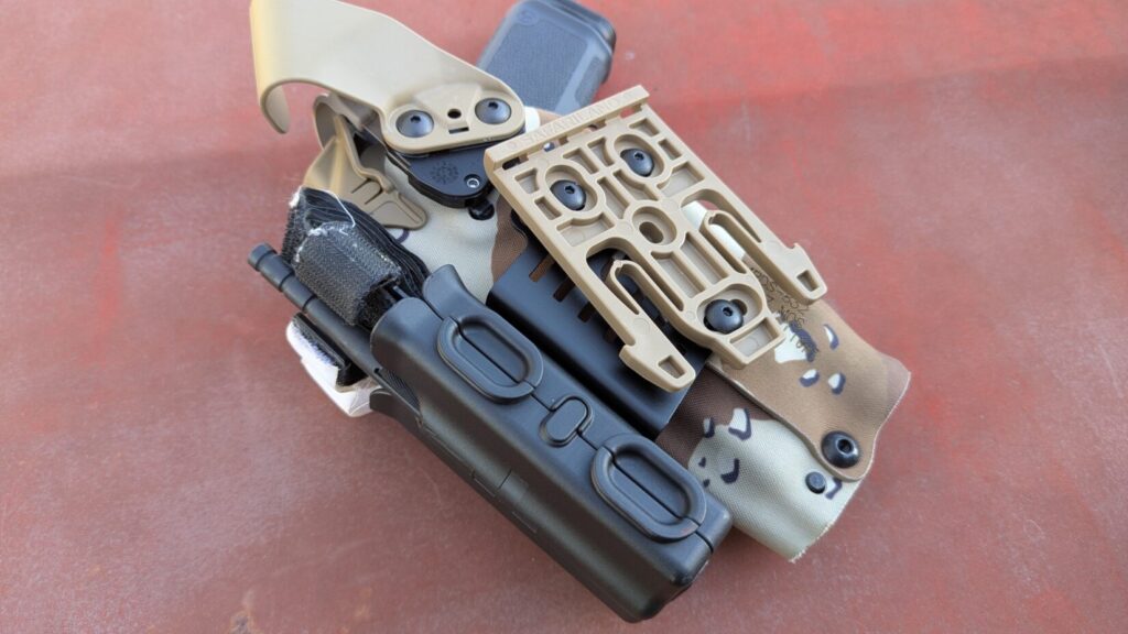 tourniquet in Safariland TQ Pouch on Chocolate chip safariland holster - showing qls fork attachment