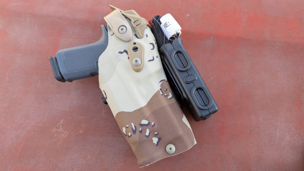 Tourniquet seated deeply in Safariland TQ Pouch with friction-fit retention.