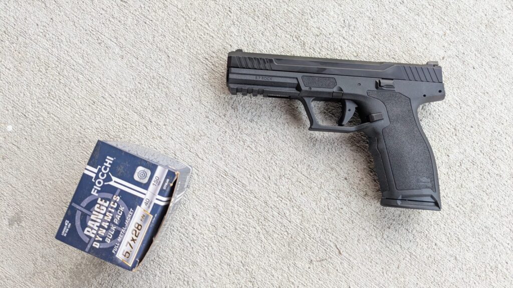 Big handgun and box of 5.7x28mm ammo