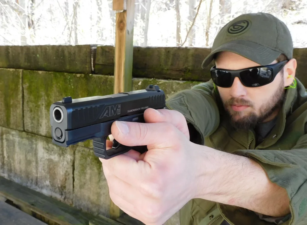 Man aiming Diamondback AM2 pistol
