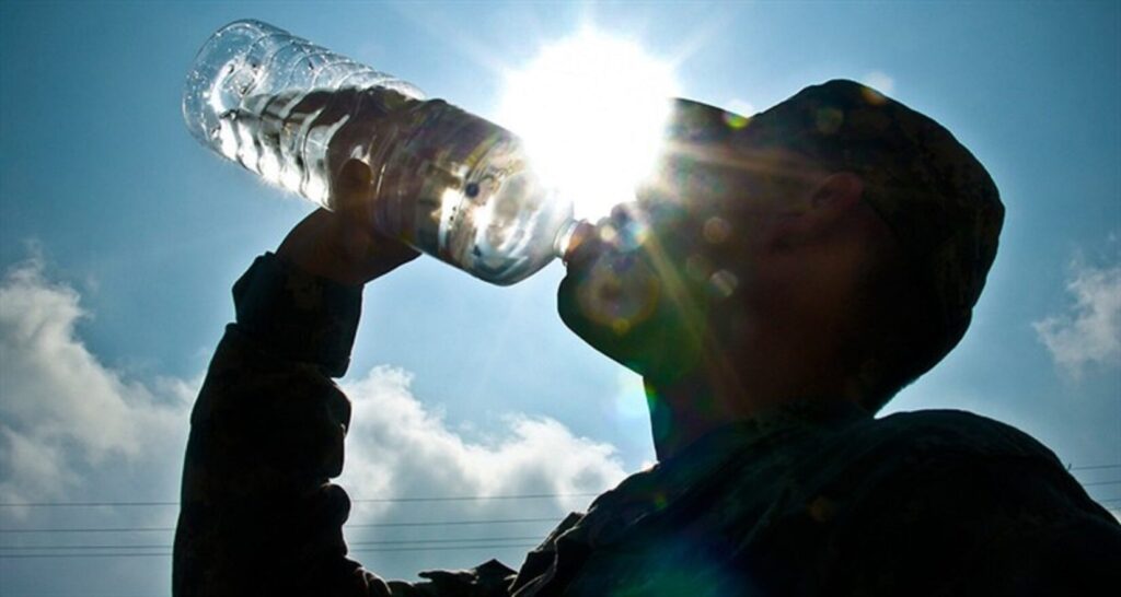 U.S. Army photo of a soldier drinking from a water bottle.