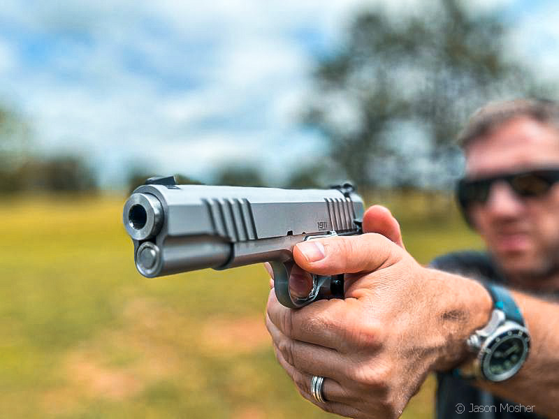 muzzle view of a man aiming the Bul Armory 1911 Government