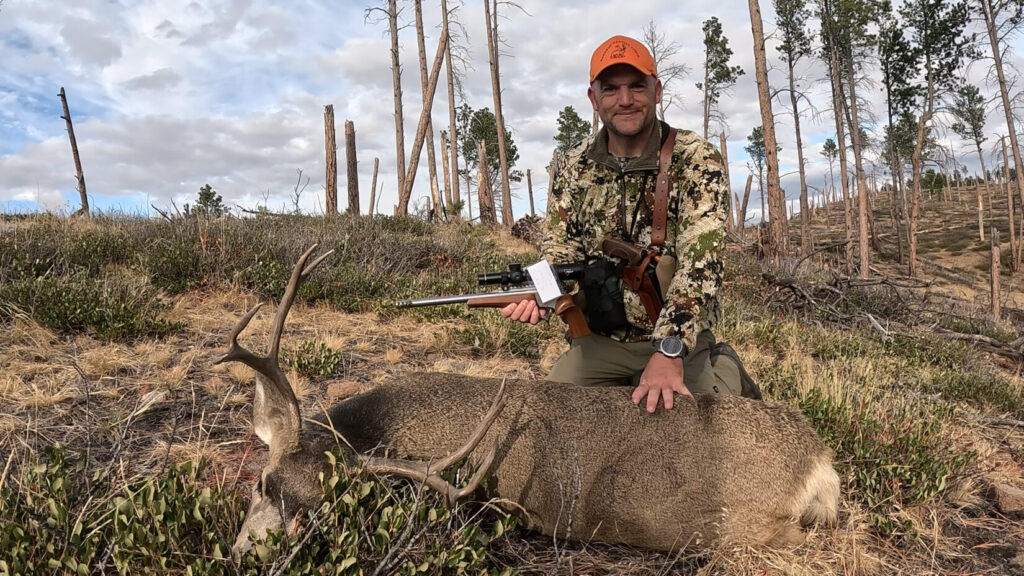 Chris with a mule deer that was taken with a TC