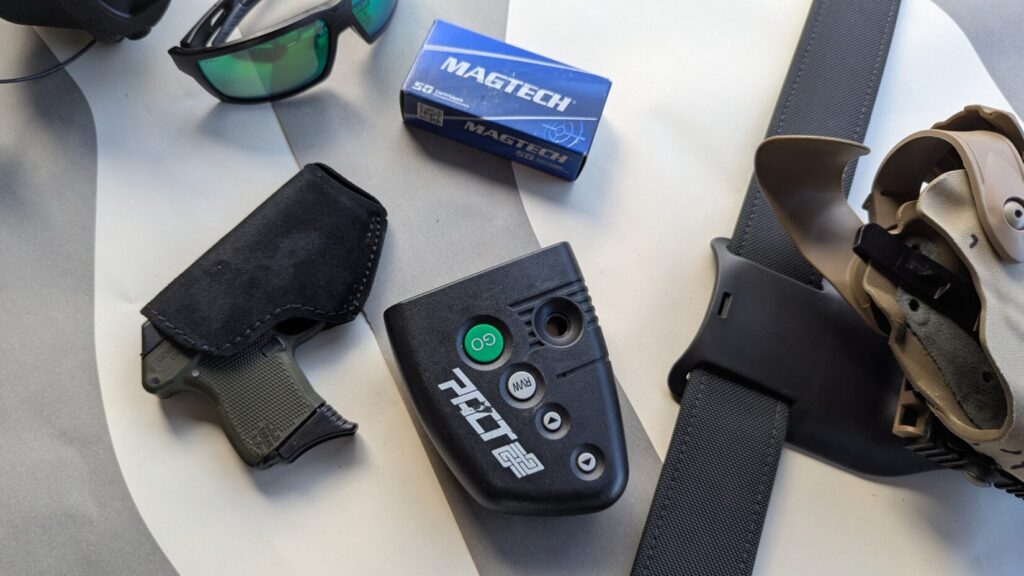 GBUW gear: handgun in pocket holster, shot timer, belt with Safariland holster, ammo, ballistic glasses