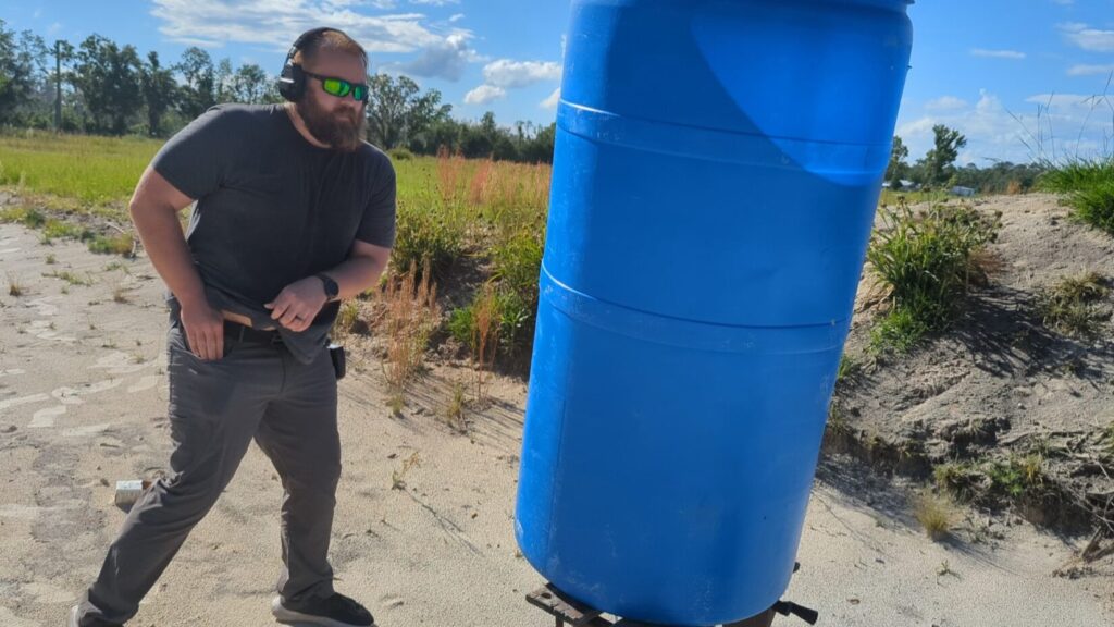 man moving behind cover while preparing to draw his pocket handgun during the Georgia backup weapon qualification