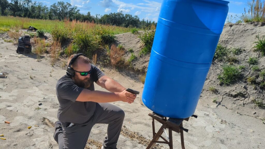man shooting Georgia Backup Weapon qualification from kneelig position from cover