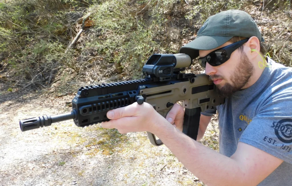 Man firing an IWI Tavor X95 rifle